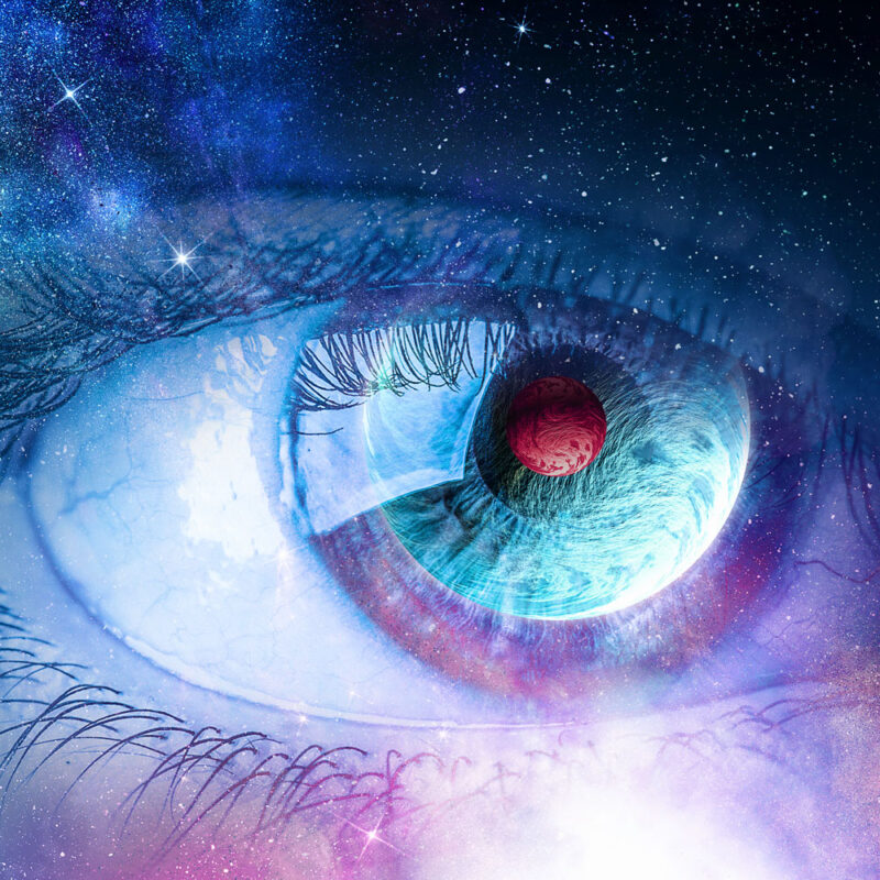 A surreal image of an eye with a cosmic landscape reflected in its iris.